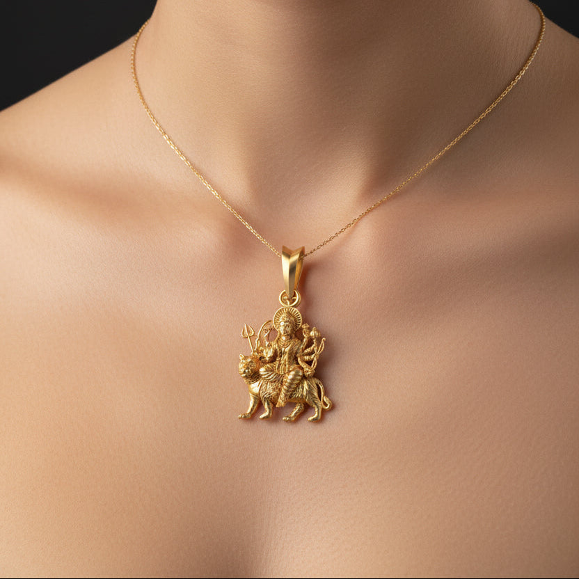 Silver pendant with a deity design on a black background