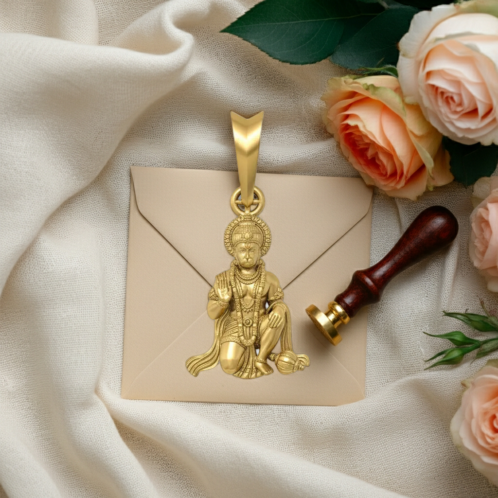 Gold pendant on a beige envelope with roses and a sealing wax stamp