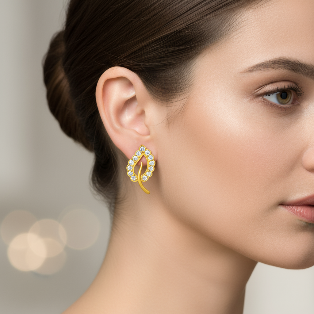 Gold earrings with clear gemstones on a black background