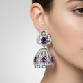 Decorative silver pendant with gemstones on a black background
