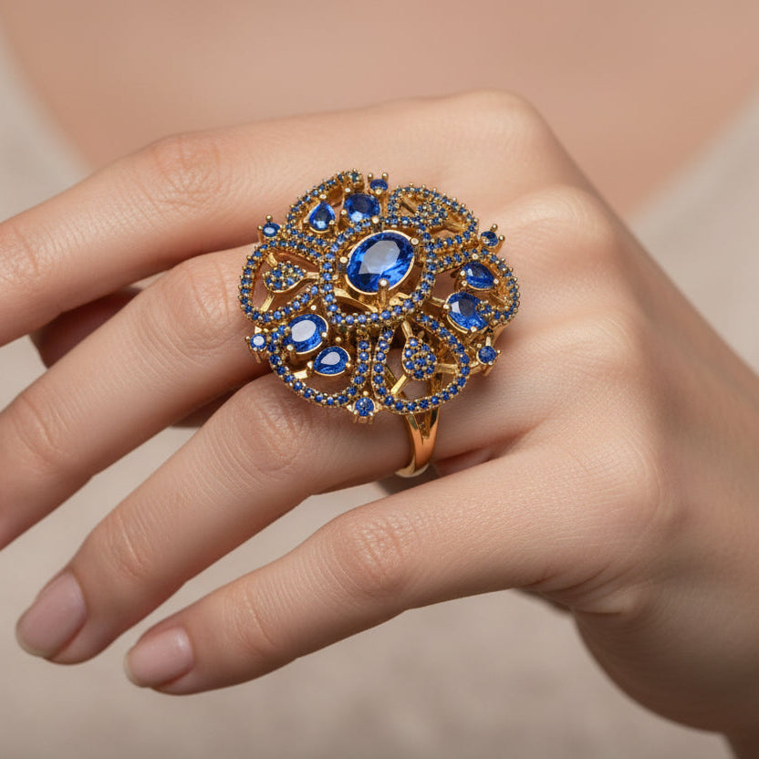 Jewelry item with blue stones and gold accents on a black background