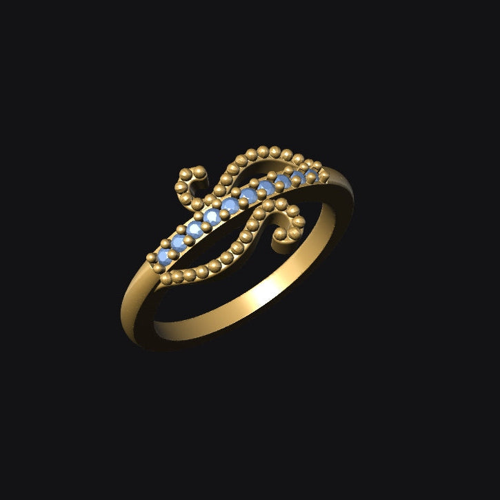 Gold ring with blue gemstones on a black background