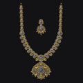 Ornate necklace with matching earrings on a black background