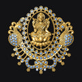 Decorative gold brooch with a central figure and gemstones on a black background