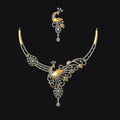 Gold necklace with peacock design on a black background