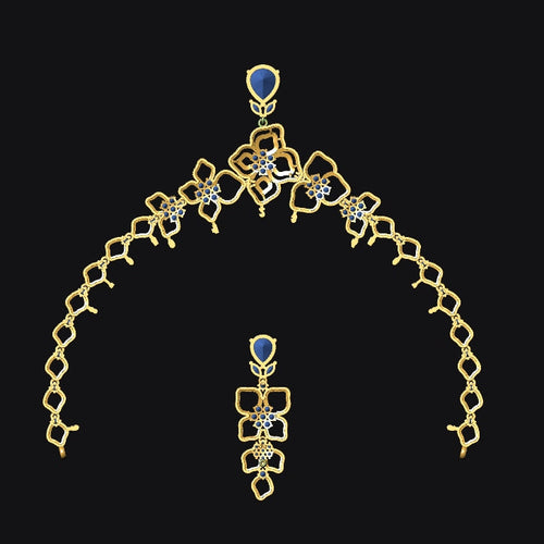 Gold necklace with blue gemstones on a black background