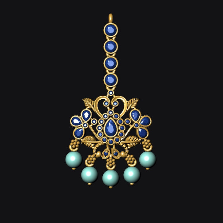 Decorative gold pendant with blue and green gemstones on a black background