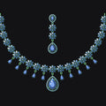 Jewelry set with necklace and earrings featuring blue and green gemstones on a black background