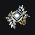 Gold ring with blue gemstone on a black background