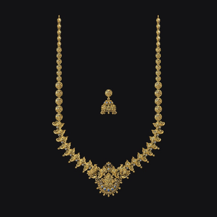 Gold necklace and earrings on a black background