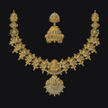 Gold necklace and earrings on a black background