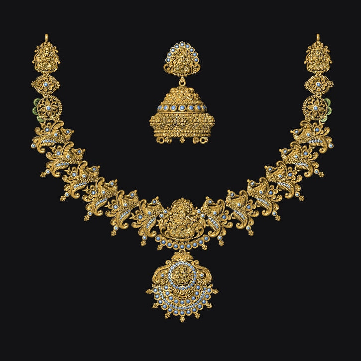 Gold necklace and earrings on a black background