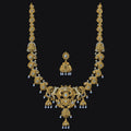 Gold necklace with matching earrings on a black background