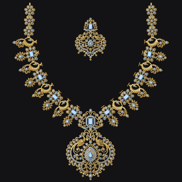 An ornate gold-toned jewelry set featuring a necklace and matching earrings, embellished with light blue stones and small clear stones, displayed on a solid black background.