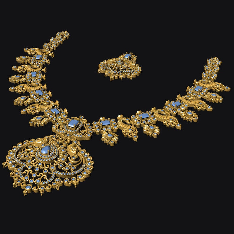 An ornate gold-toned jewelry set on a solid black background, featuring a necklace with a large pendant, matching earrings, and a small accessory piece. The jewelry is detailed with gold filigree and small light blue gemstone accents.