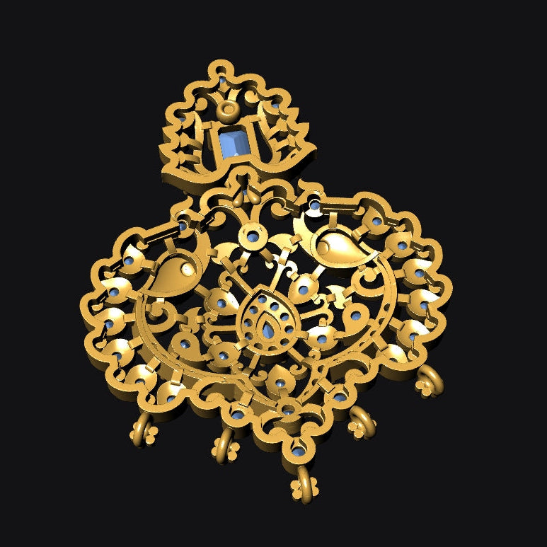 An ornate gold-toned filigree pendant or brooch with intricate cutout detailing, small white accents, and a tiny blue inset near the top, shown on a solid black background.