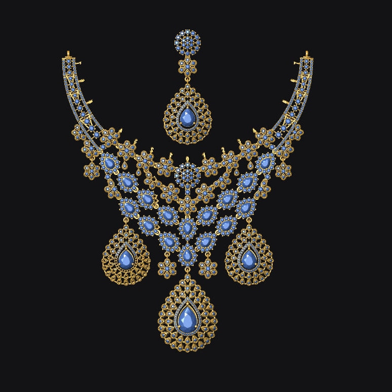 An ornate gold-toned jewelry set featuring a necklace and matching earring, both decorated with intricate filigree and large blue teardrop gemstones, set against a solid black background.