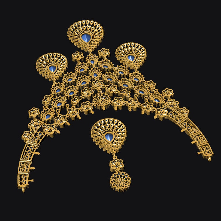 An ornate gold-toned traditional jewelry piece with multiple circular and teardrop-shaped embellishments, accented by small blue stones, shown on a solid black background.