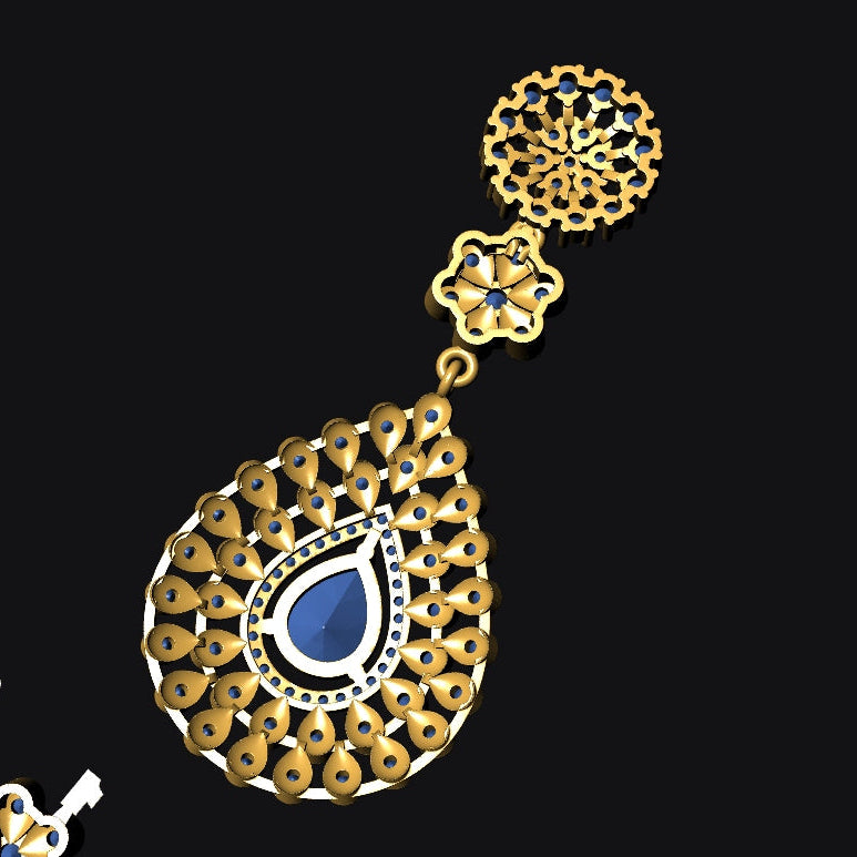 An ornate gold teardrop earring with intricate filigree detailing and a central blue stone, displayed against a solid black background.