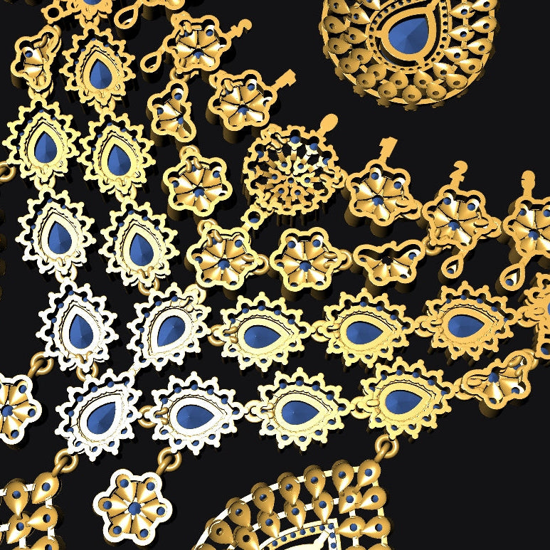 Gold and silver-toned filigree jewelry set with blue stone accents, arranged on a solid black background.