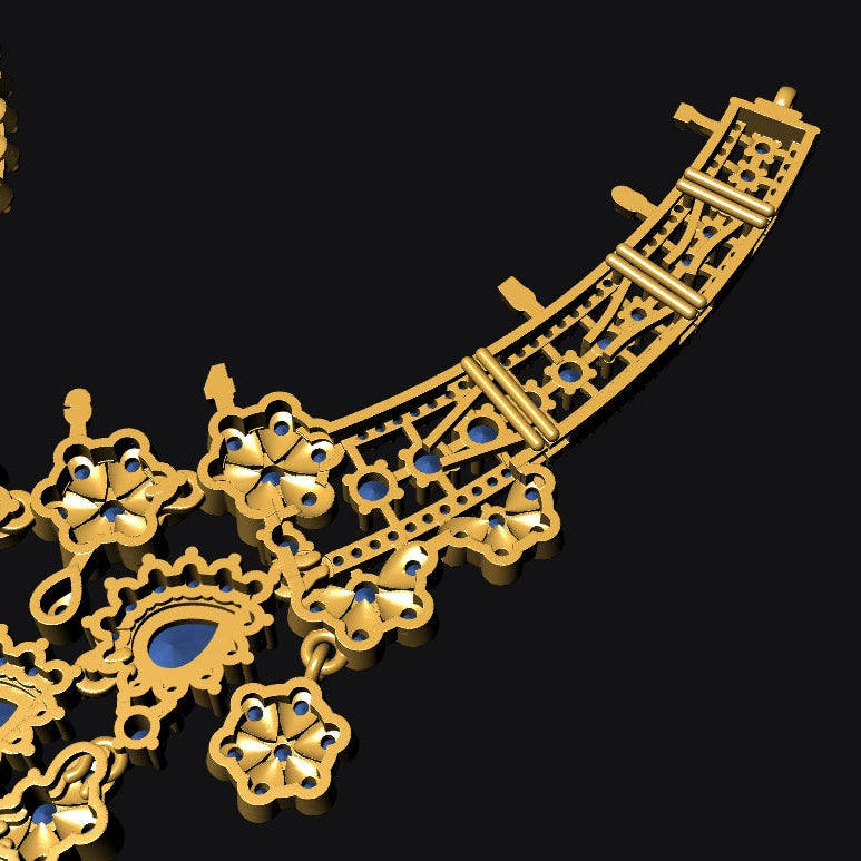 Gold-toned ornate jewelry set featuring a curved necklace and matching teardrop pendant, both decorated with intricate filigree, floral motifs, and small blue stone accents, shown on a black background.