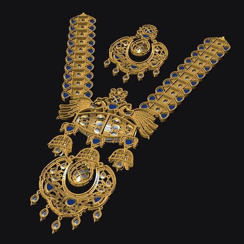 An ornate gold-toned jewelry piece with intricate filigree detailing and multiple blue gemstone accents, displayed on a solid black background.