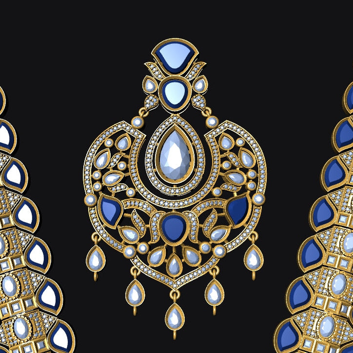 An ornate gold jewelry set displayed on a solid black background, featuring a central teardrop pendant and two matching curved necklaces or bracelets decorated with deep blue stones and clear pavé accents.