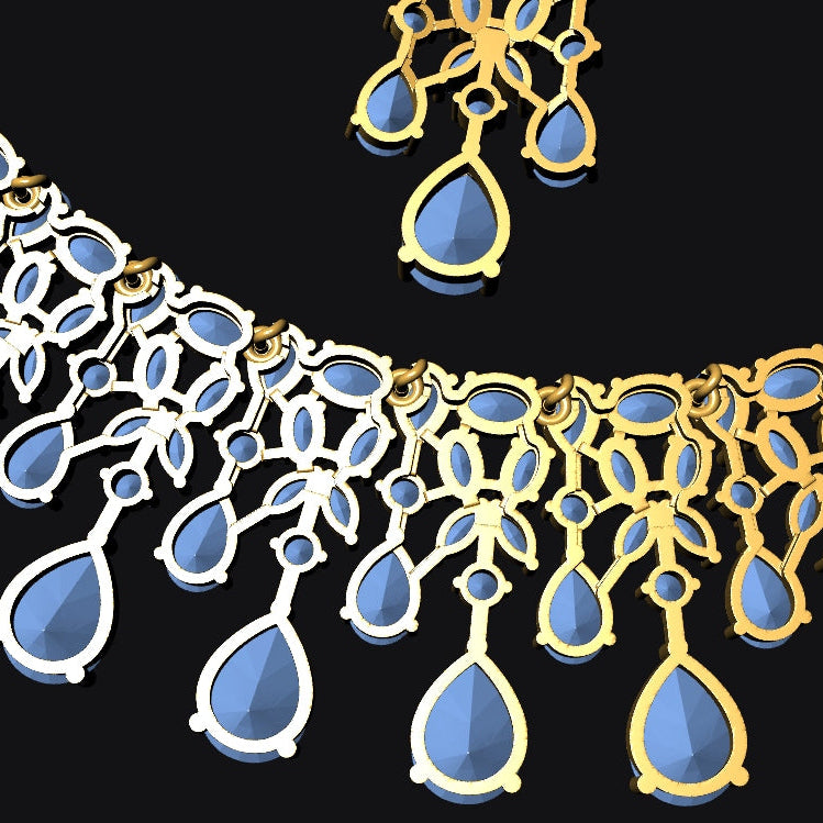 A close-up of a gold and silver-toned teardrop pendant necklace with light blue faceted stones, shown against a solid black background.