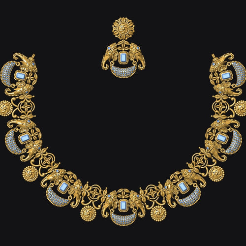 An ornate gold-toned jewelry set featuring a necklace and matching earring, decorated with intricate scrollwork, floral motifs, and oval blue-and-white stone inlays, displayed against a solid black background.