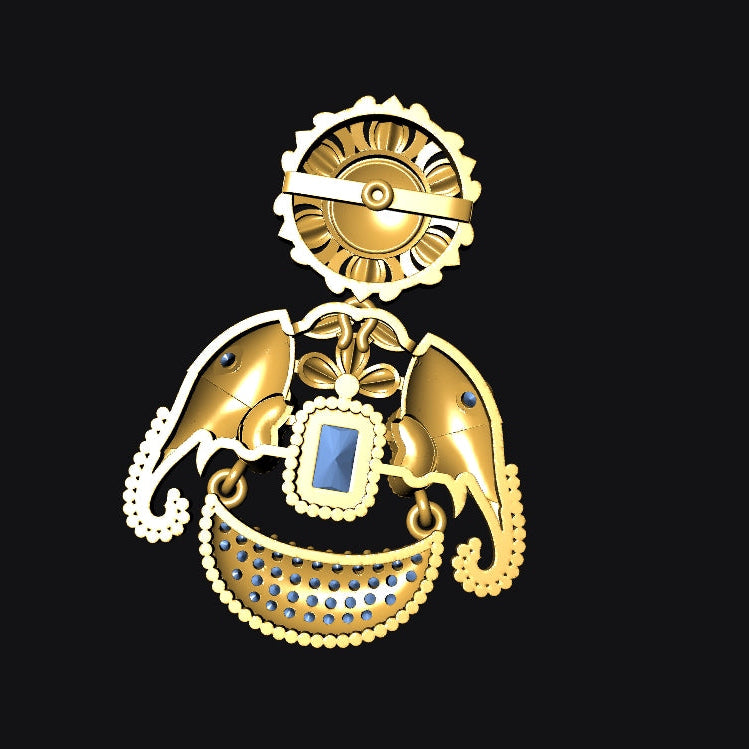 A gold-toned ornate pendant or brooch featuring a circular top element, curved wing-like side details, a central rectangular blue stone, and a decorative beaded lower section, shown on a solid black background.