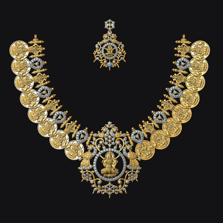 An ornate gold-toned traditional necklace set with a matching pendant, featuring circular coin-like motifs and small blue gemstone accents, displayed on a solid black background.