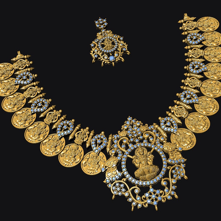 An ornate gold-toned jewelry set on a black background, featuring a coin-style necklace with central portrait medallion and matching earrings.