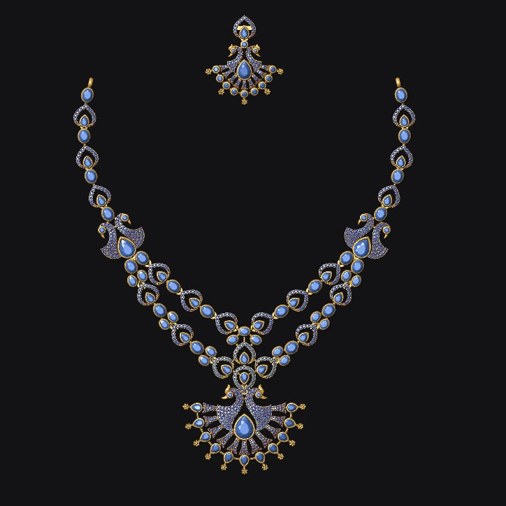 An ornate gold-toned double-strand necklace with a matching stud earring, featuring light blue stones and gold accents, displayed against a solid black background.