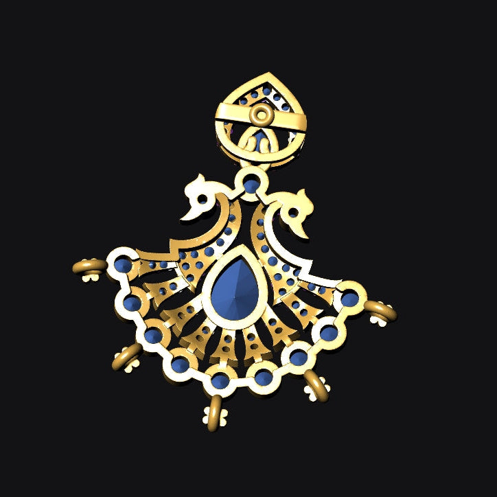 A gold-toned pendant or charm with a central blue teardrop stone, ornate filigree detailing, and small circular blue accents, shown on a solid black background.