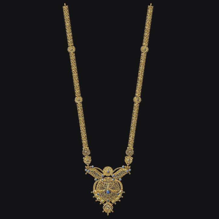 A gold-toned traditional necklace with a detailed pendant, shown against a solid black background.
