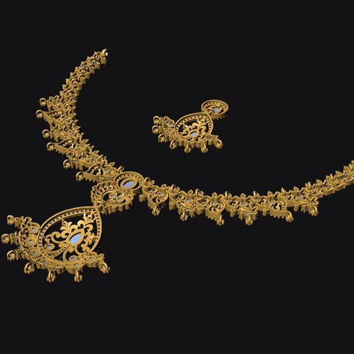 An ornate gold-toned jewelry set featuring a curved necklace with a detailed paisley pendant and matching earrings, displayed against a solid black background.
