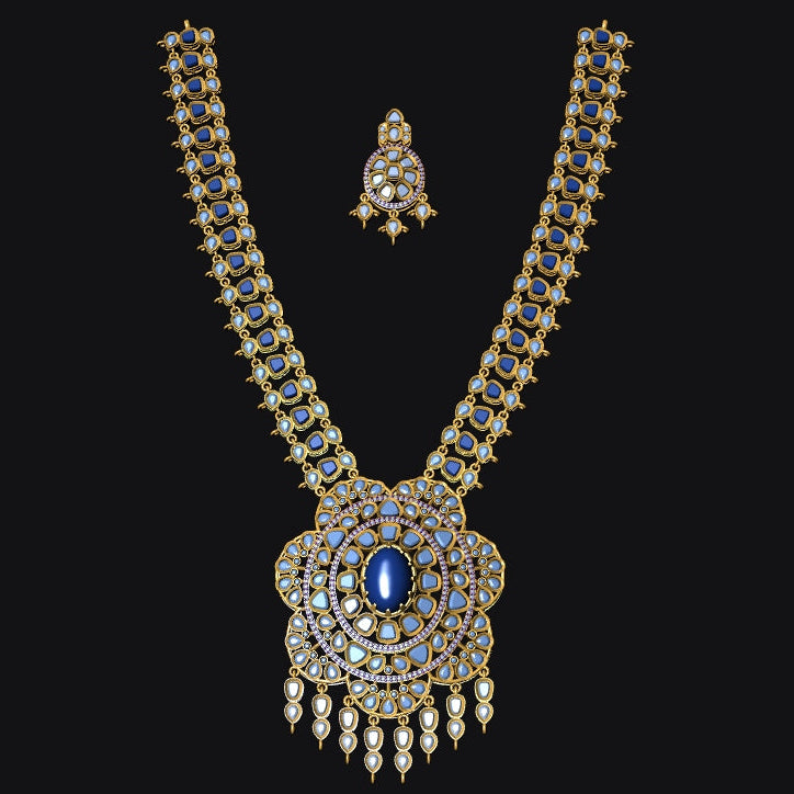 An ornate gold-toned traditional necklace set with a large pendant and matching small pendant, heavily embellished with blue stones and clear gemstones, displayed on a solid black background.