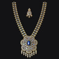 An ornate gold-toned traditional necklace set with a large pendant and matching small pendant, heavily embellished with blue stones and clear gemstones, displayed on a solid black background.